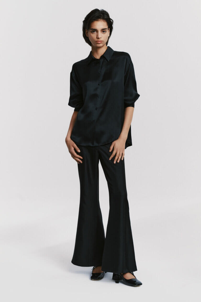 Elegant black silk shirt with a smooth satin finish styled with silk trousers