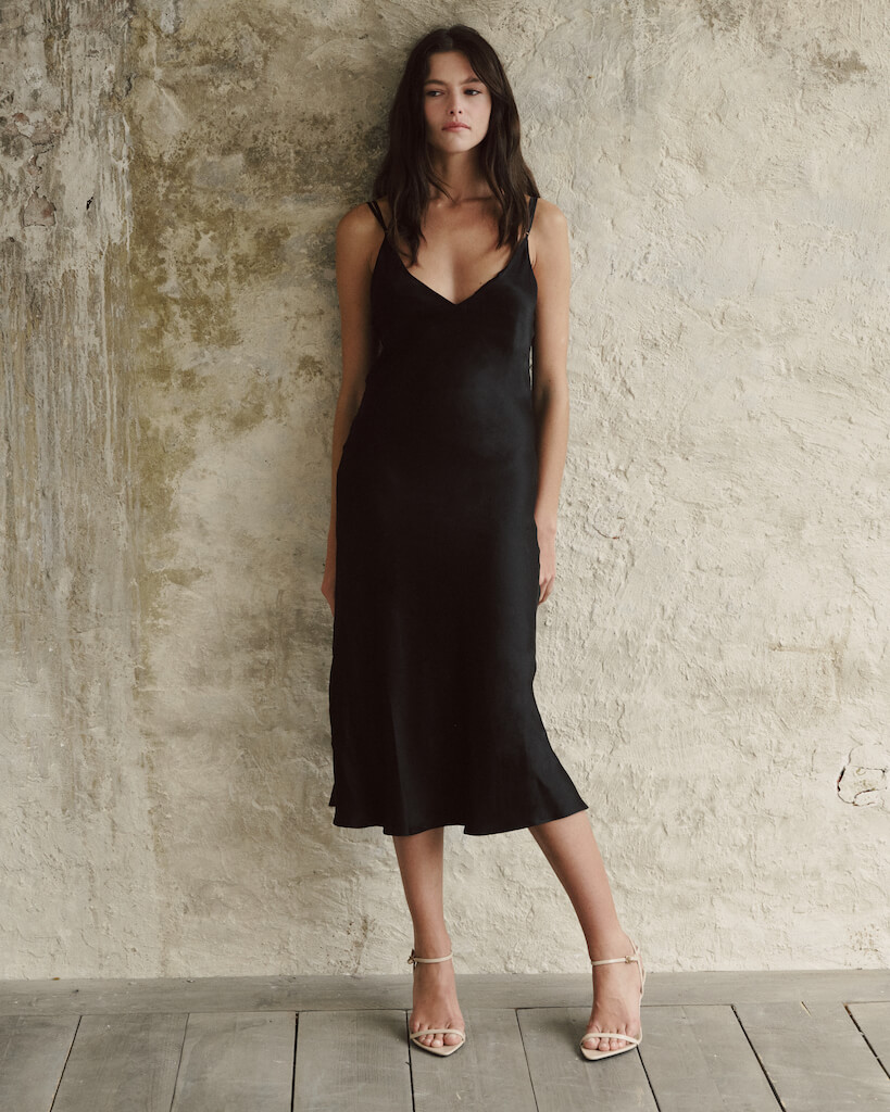 Model wearing elegant and classy silk black midi dress.